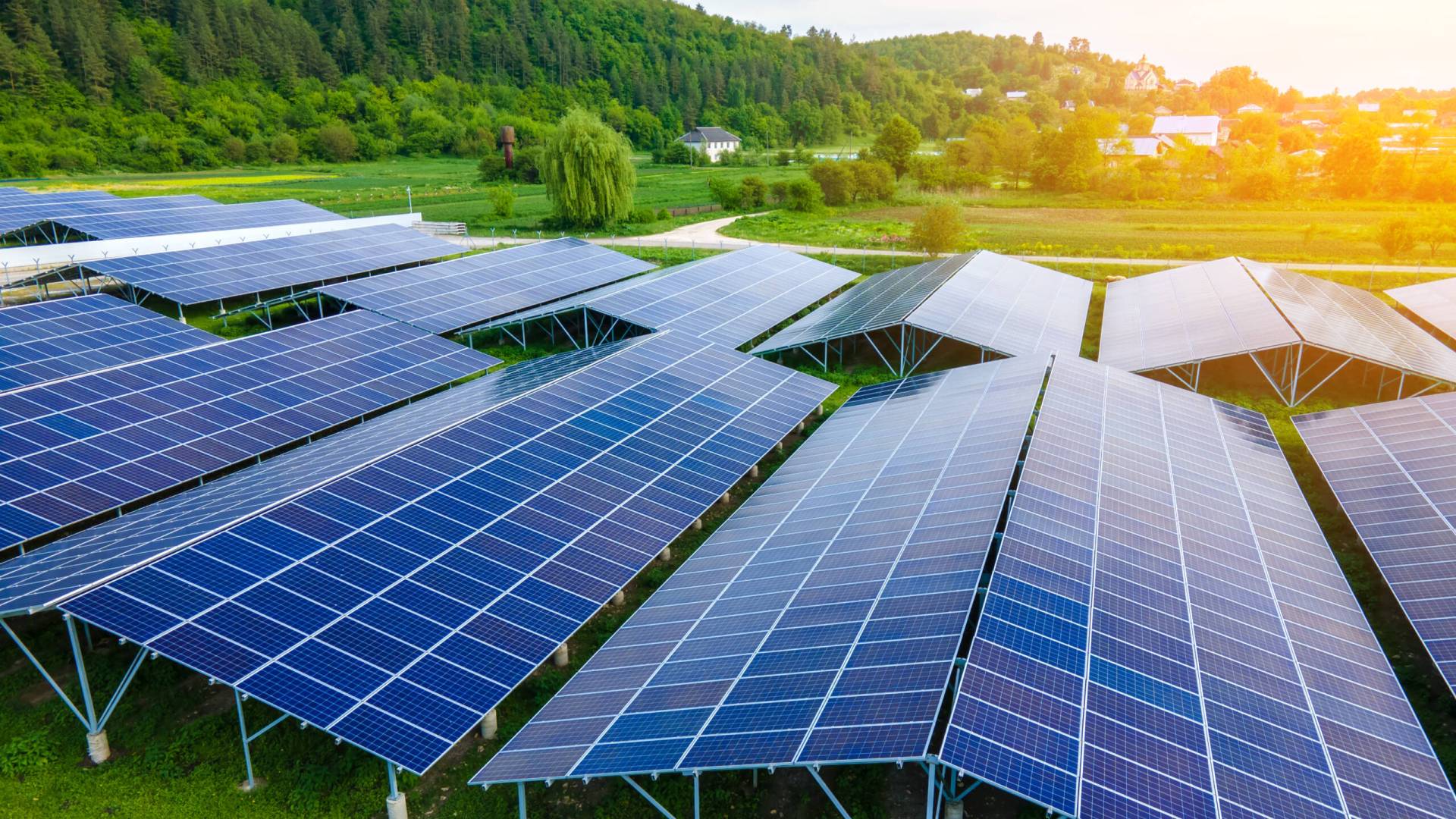 Aerial view of large sustainable electrical power plant with rows of solar photovoltaic panels for producing clean ecological electric energy. Renewable electricity with zero emission concept. Aerial view of large sustainable electrical power plant with rows of solar photovoltaic panels for producing clean ecological electric energy. Renewable electricity with zero emission concept.